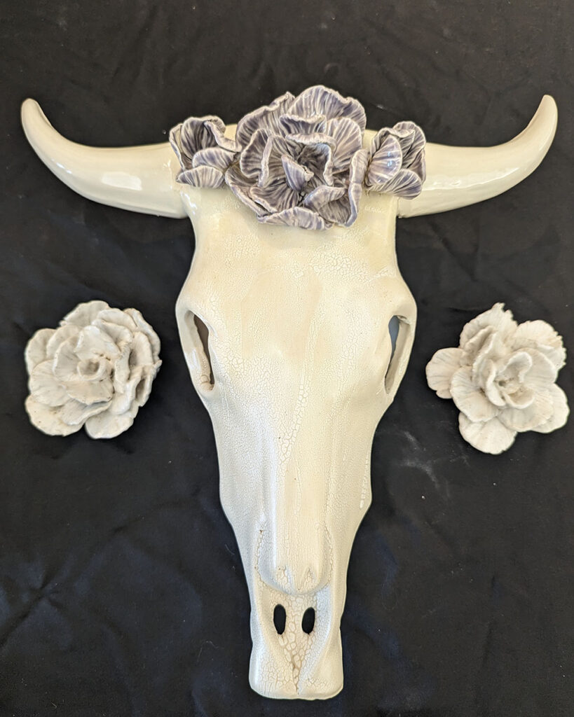 Ceremaic creation of florals and animal skull.