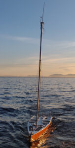 A robotic sailing vessel is out on water.