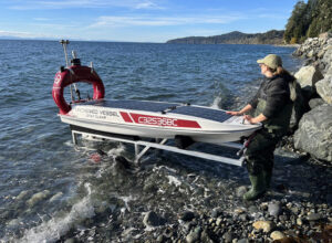 A data collection device being dragged on to the shore